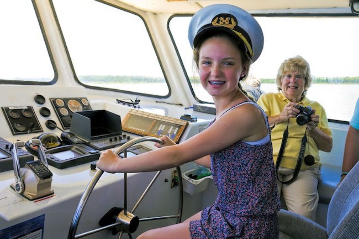 Passenger enjoys a photo-op during a Destin dolphin sightseeing cruise