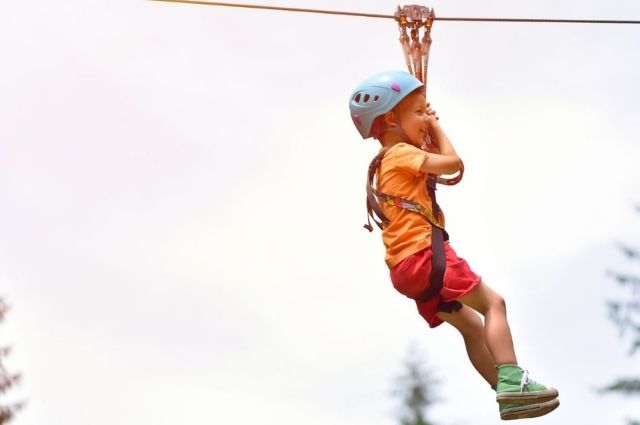 child ziplining at Baytowne Adventure Zone